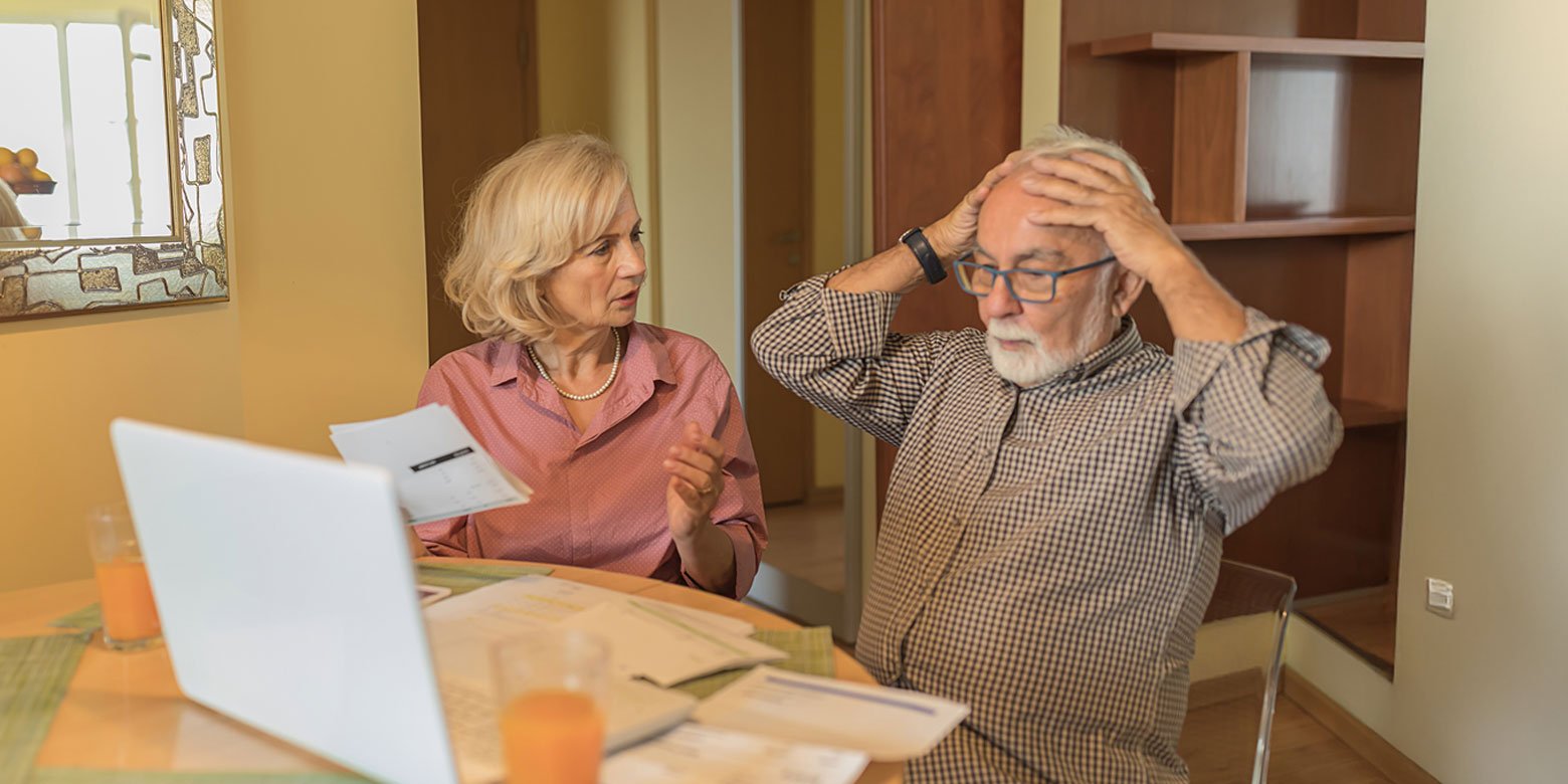 Retirement age couple stressing over paperwork