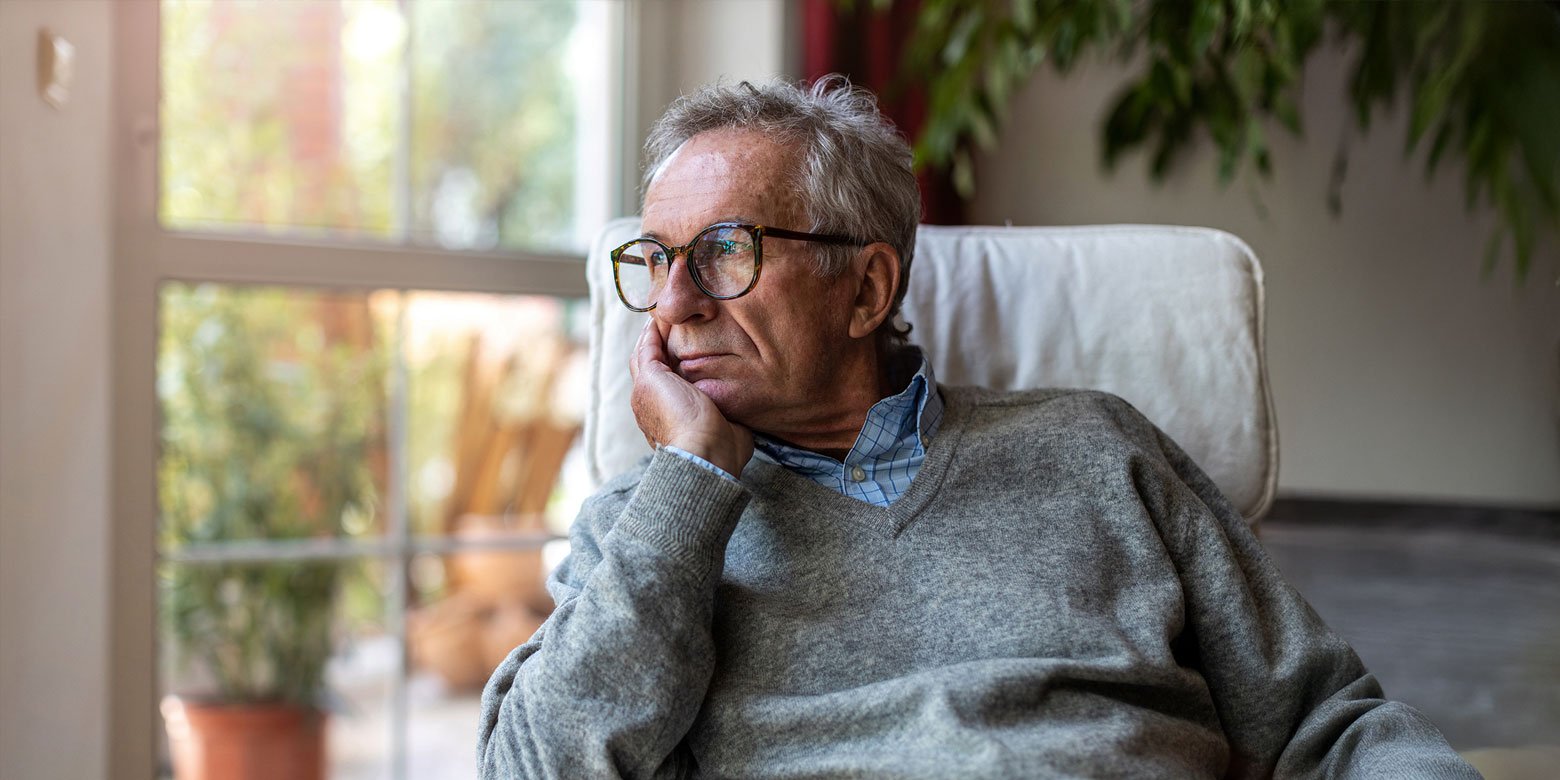 Older man staring out the window