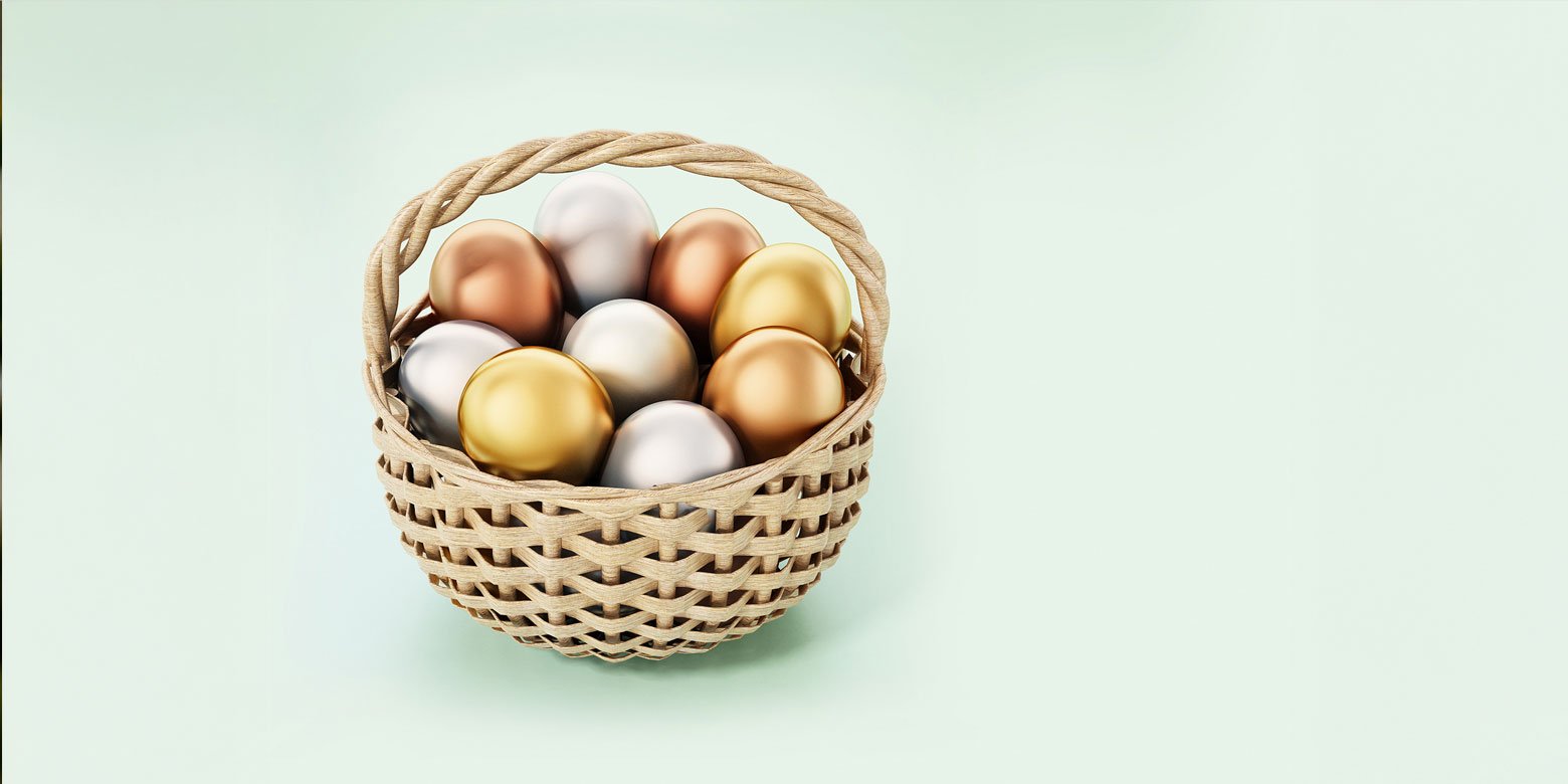 Gold, silver and bronze eggs in a basket
