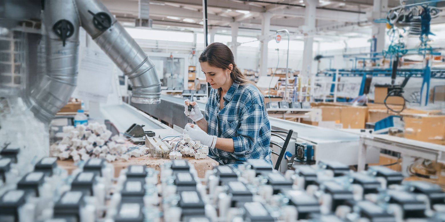 Woman at a factory packaging goods